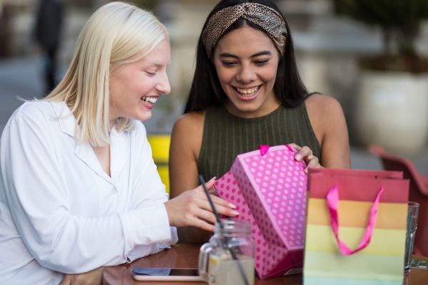 a women giving a friend a gift